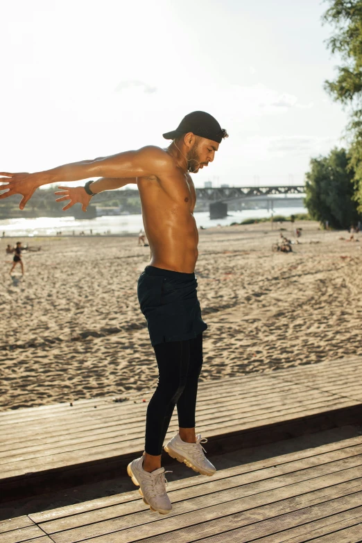 a man doing a trick on a skateboard on a boardwalk, an album cover, pexels contest winner, figuration libre, sweaty abs, wearing fitness gear, his arms spread. ready to fly, gif