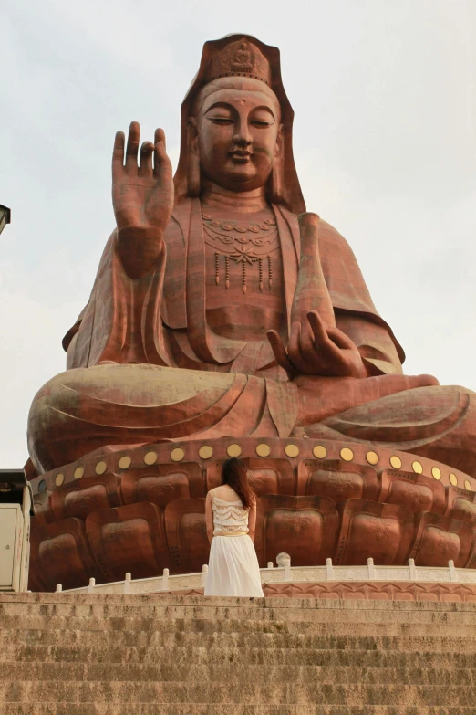 a person standing in front of a large statue, a statue, sitting on a lotus flower, maroon, 2 5 6 x 2 5 6 pixels, jen zee