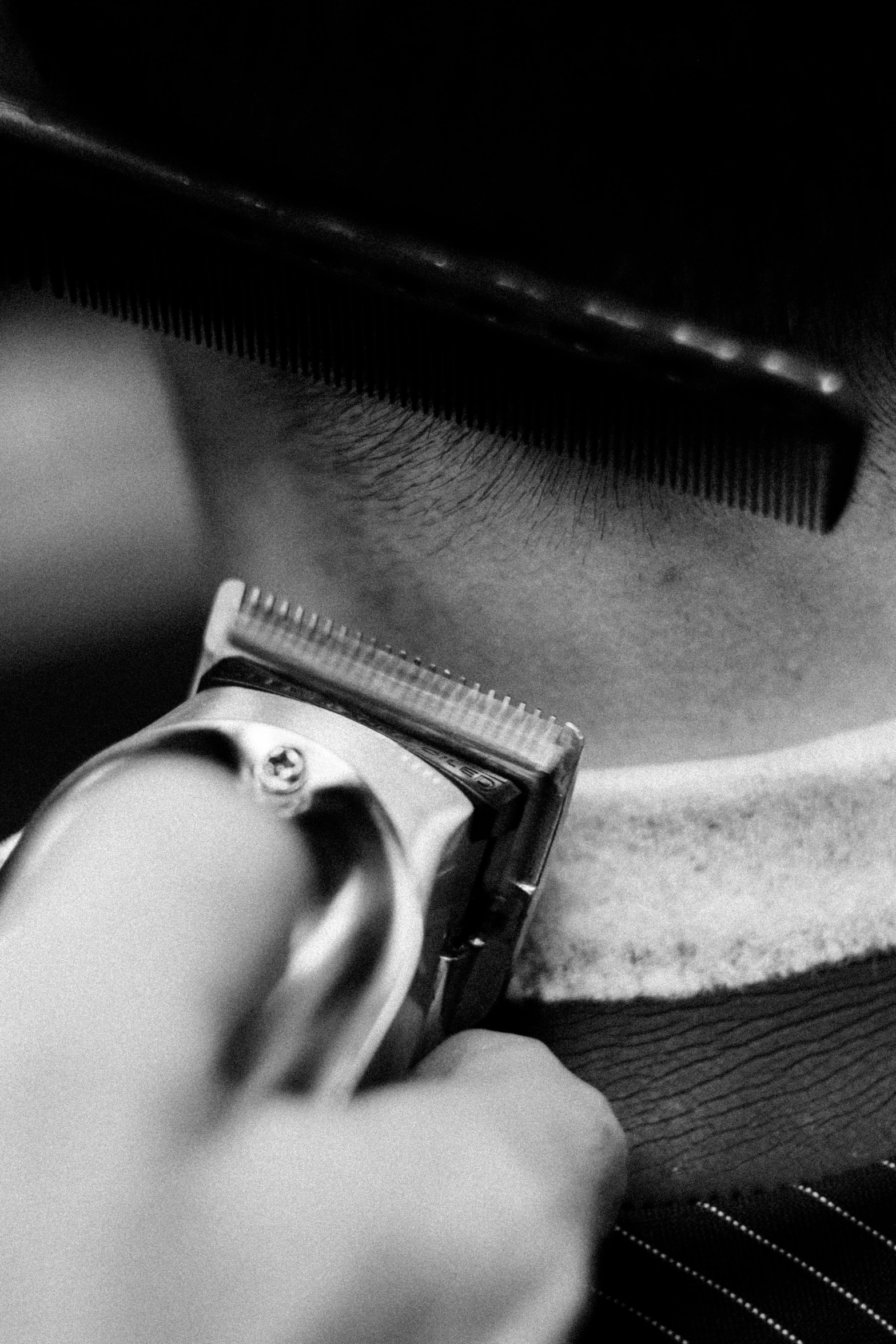 a close up of a person cutting a mans neck, a black and white photo, by Dave Melvin, flat top haircut, headshot profile picture, wavy, trim
