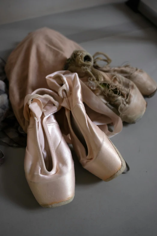 a pair of ballet shoes sitting on top of a table, slide show, vessels, more, ap