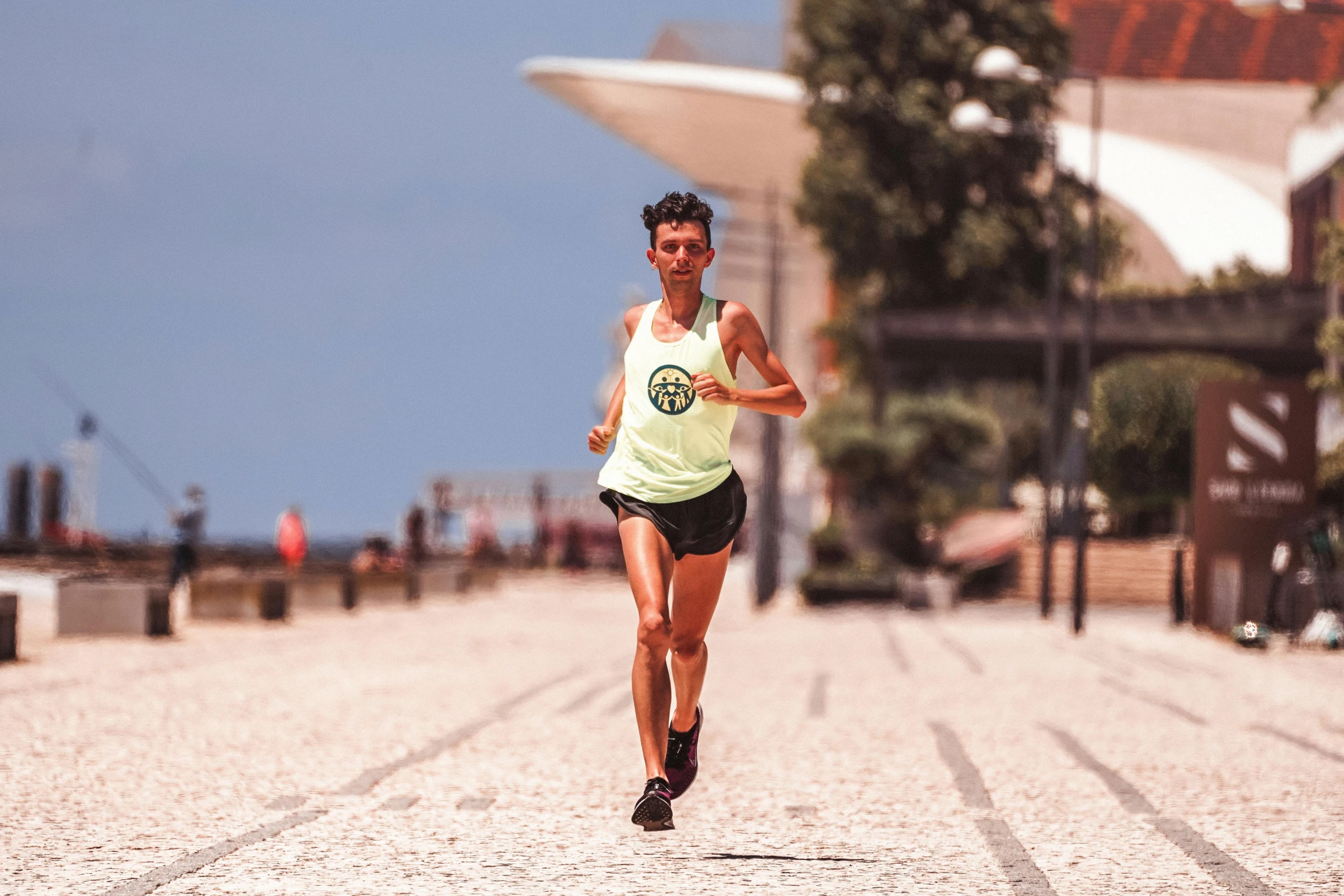 a woman running down a street on a sunny day, by Sam Black, pexels contest winner, athletic tall handsome guys, avatar image, diego fernandez, epic 3 d omolu