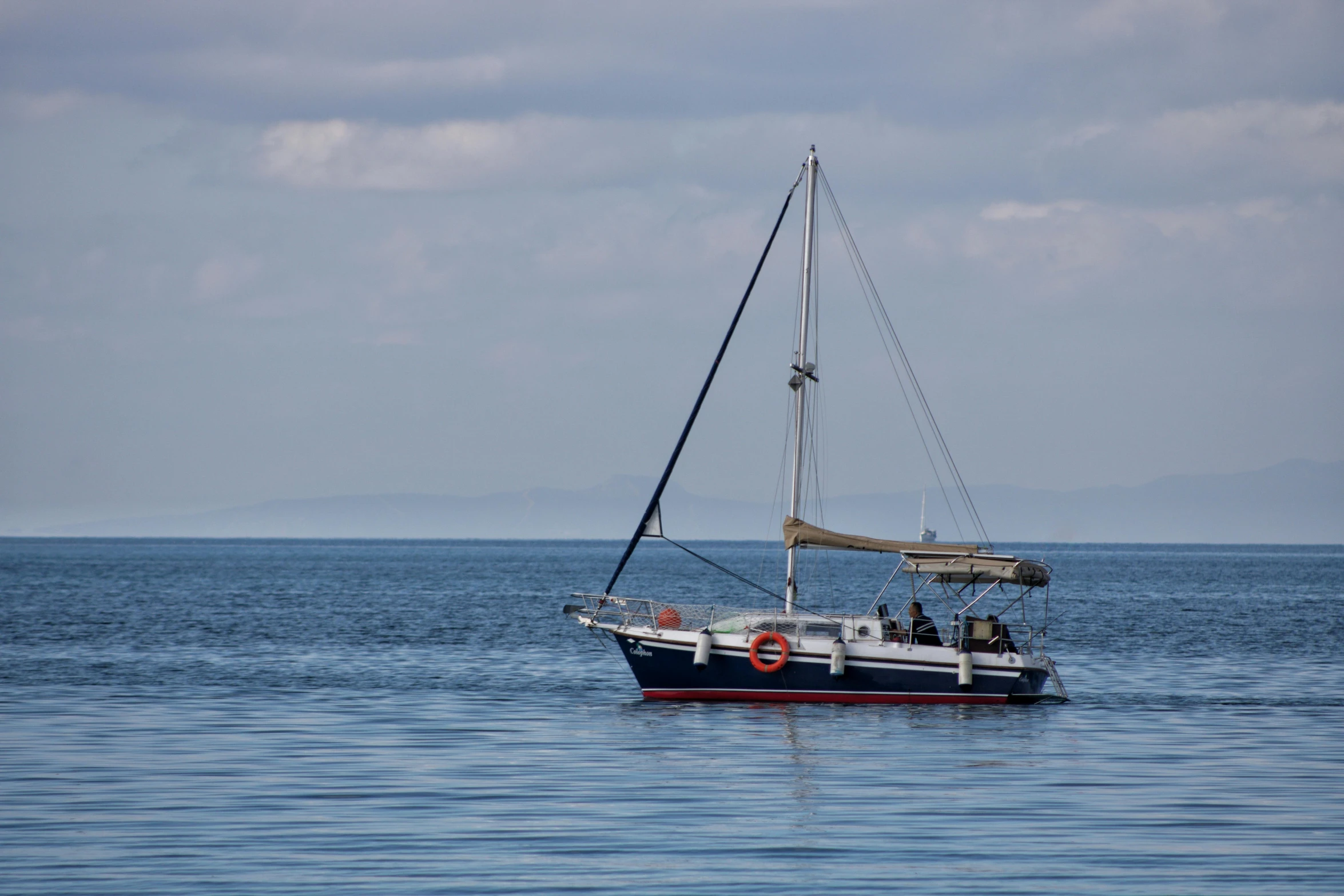 a boat floating on top of a large body of water, pexels contest winner, sails and masts and rigging, blue print, skye meaker, three quarter profile