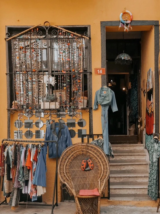 a brown wicker chair sitting in front of a store, trending on pexels, egyptian clothes, elaborate jewelry, gif, alleys