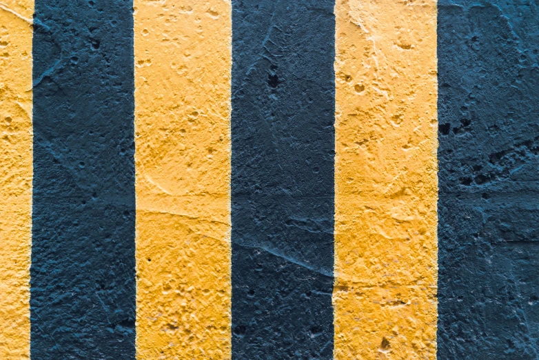 a close up of a yellow and black striped wall, by Carey Morris, unsplash, artwork about a road to freedom, square, three colors, concrete