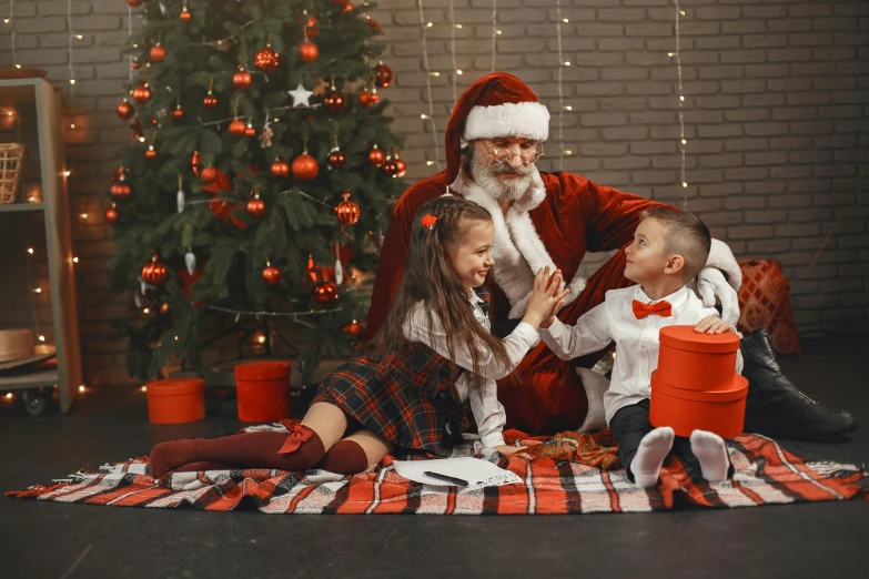 a man and two children sitting on a blanket in front of a christmas tree, pexels contest winner, kramskoi 4 k, santa clause, 5 years old, wearing a red plaid dress