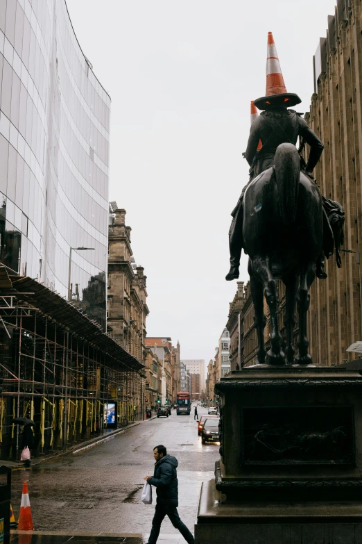 a statue of a man riding on the back of a horse, inspired by Gawen Hamilton, pexels contest winner, rainy streets in the background, glasgow, tall hat, facing away from camera