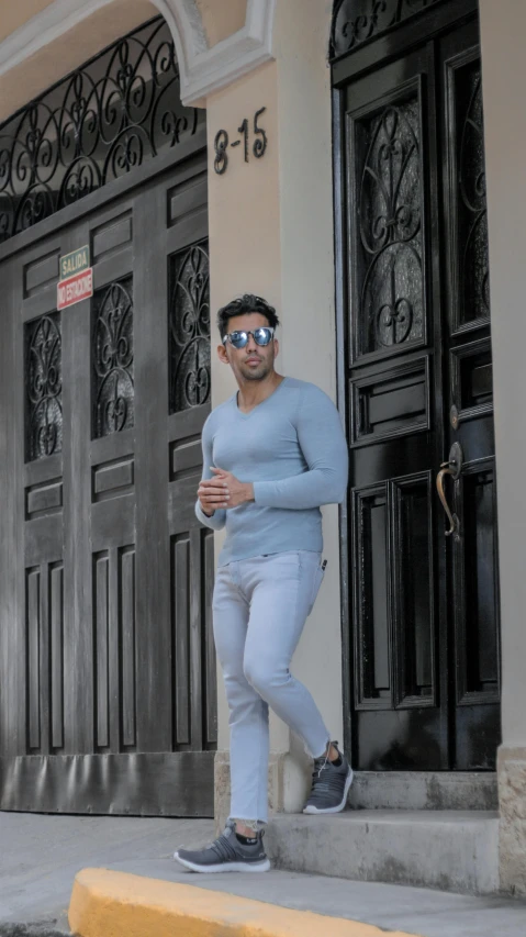 a man riding a skateboard down a sidewalk, a colorized photo, inspired by david rubín, pexels contest winner, renaissance, wearing mirrored sunglasses, white and pale blue, leaning on door, reza afshar