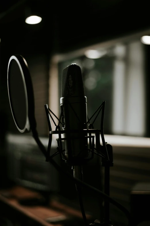 a close up of a microphone in a recording studio, an album cover, pexels, tall, looking outside, pitch black room, multiple stories