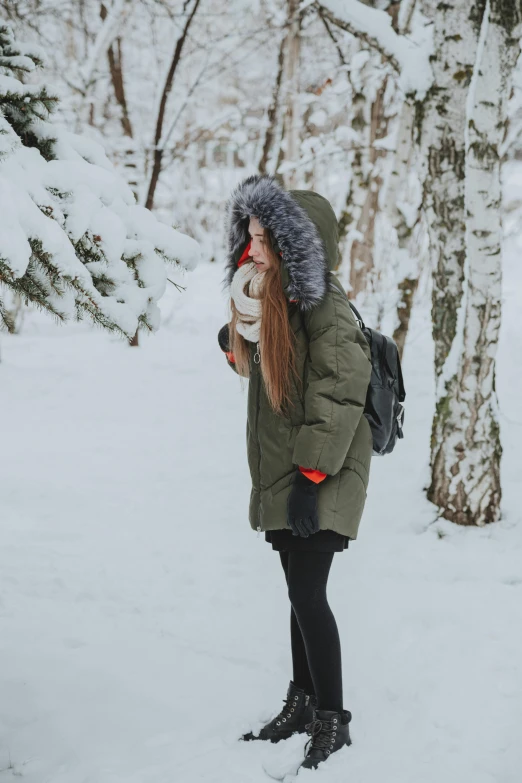 a woman in a parka standing in the snow, pexels contest winner, greenery, side view of her taking steps, russian girlfriend, profile image