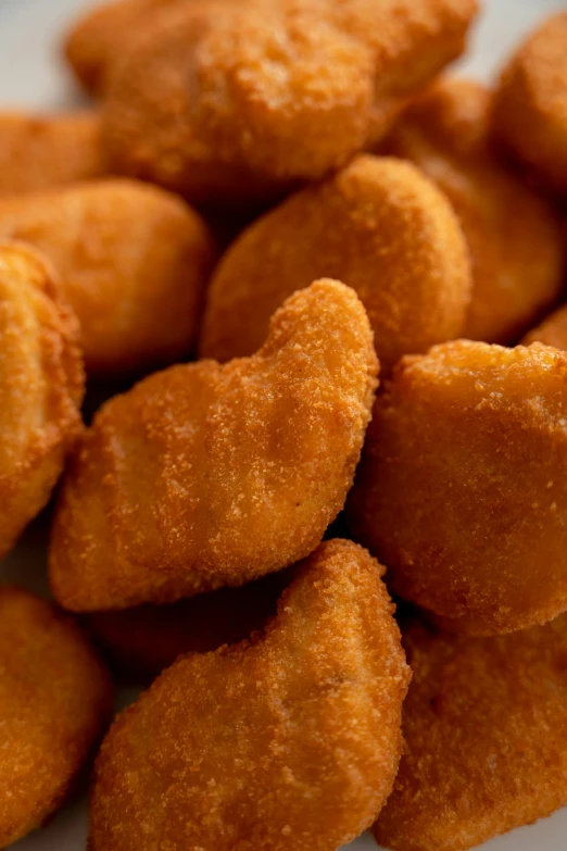 a pile of fried chicken nuggies on a plate, smooth shapes, (heart), 15081959 21121991 01012000 4k, detail shot