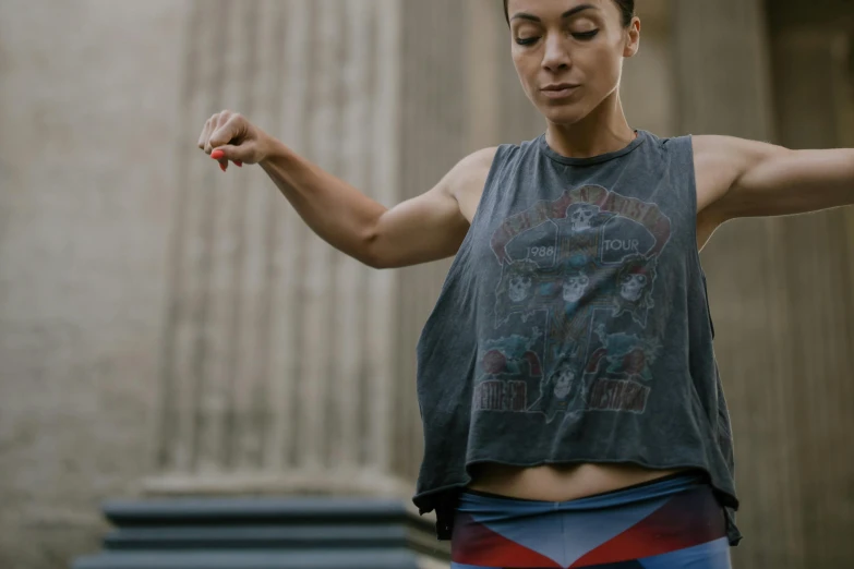 a woman holding a tennis racquet in one hand and a tennis racquet in the other, pexels contest winner, graffiti, wearing a muscle tee shirt, gal gadot as captain america, cropped red yoga short, liberty leading the people