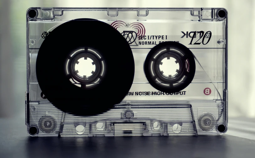 a close up of a cassette on a table, an album cover, inspired by Ryoji Ikeda, pexels, graffiti, noise effects filter, type - 2, 40mm tape, boombox