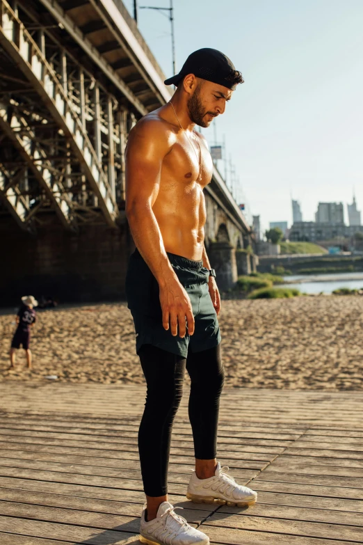 a shirtless man riding a skateboard on a boardwalk, pexels contest winner, renaissance, man in adidas tracksuit, attractive muscular man, standing in sand, gif