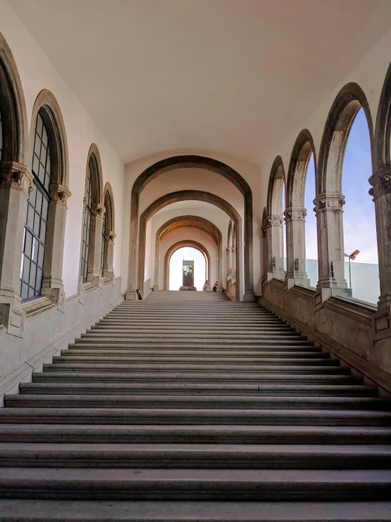 a set of stairs leading up to the top of a building, inspired by Luis Paret y Alcazar, pexels contest winner, renaissance, giant majestic archways, 2 5 6 x 2 5 6 pixels, looking off into the distance, large open windows