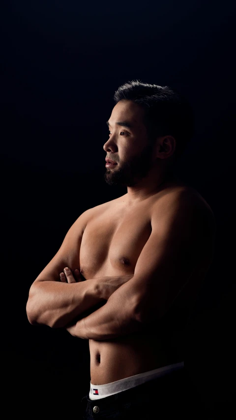 a shirtless man standing with his arms crossed, by Robbie Trevino, sumo wrestler, lit from the side, darren quach, contemplating