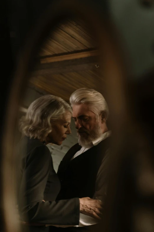 a man and a woman standing in front of a mirror, silver hair and beard, cinematic still of westworld, ignant, a seance