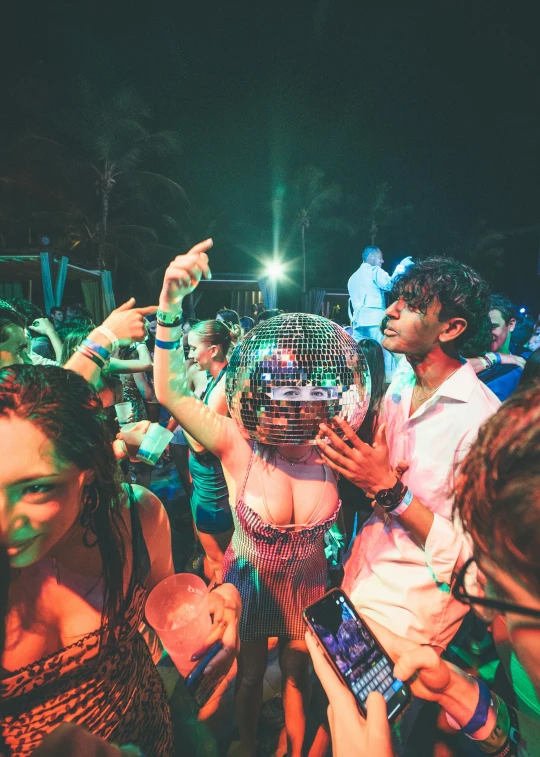 a group of people standing around a disco ball, bali, profile image, photograph of three ravers, crowd