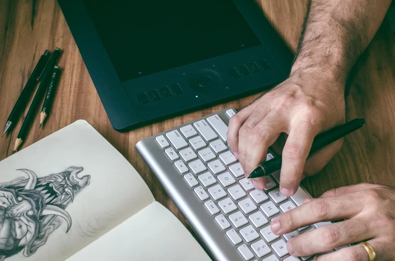 a close up of a person typing on a keyboard, a digital rendering, trending on pexels, aaron horkey, drawing sketches on his notebook, 9 9 designs, no - text no - logo