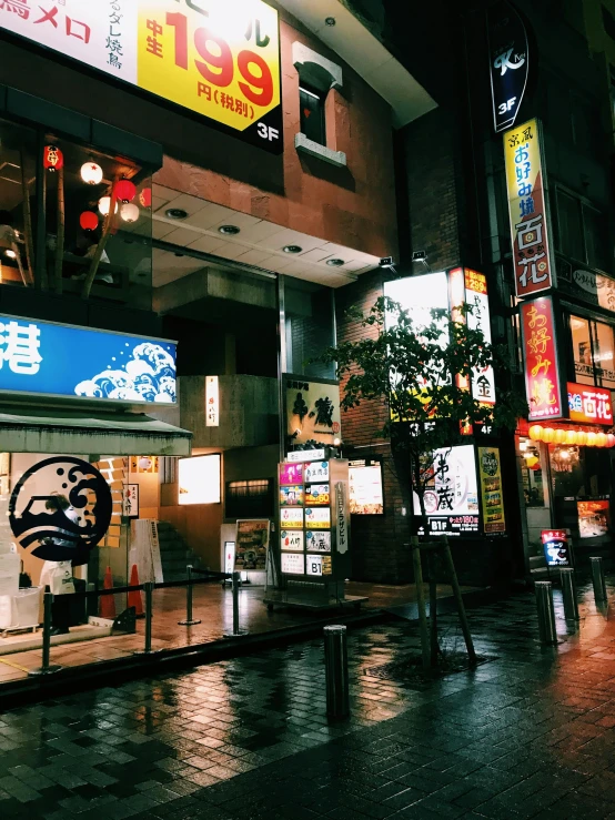 a building that has a lot of signs on it, unsplash, ukiyo-e, rainy night city street, photo on iphone, high quality image