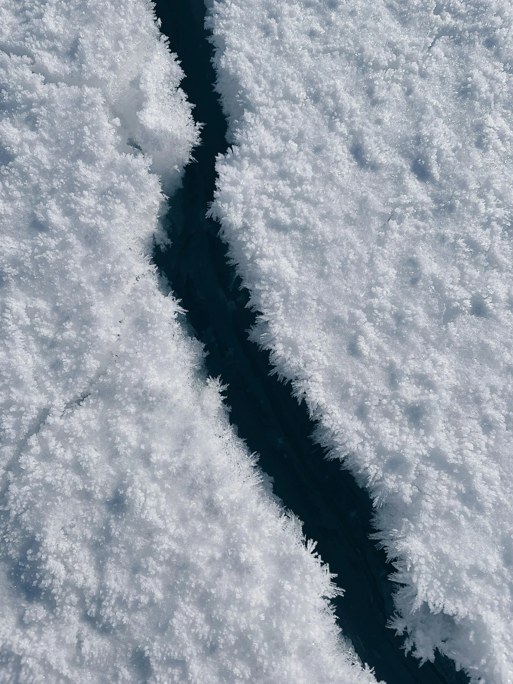 a stream of water running through a snow covered field, inspired by Andy Goldsworthy, pexels contest winner, close-up from above, north pole, thumbnail, multiple stories