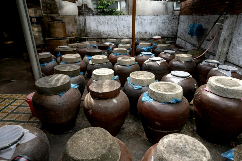 a room filled with lots of pots sitting next to each other, bao phan, yard, jars, profile image