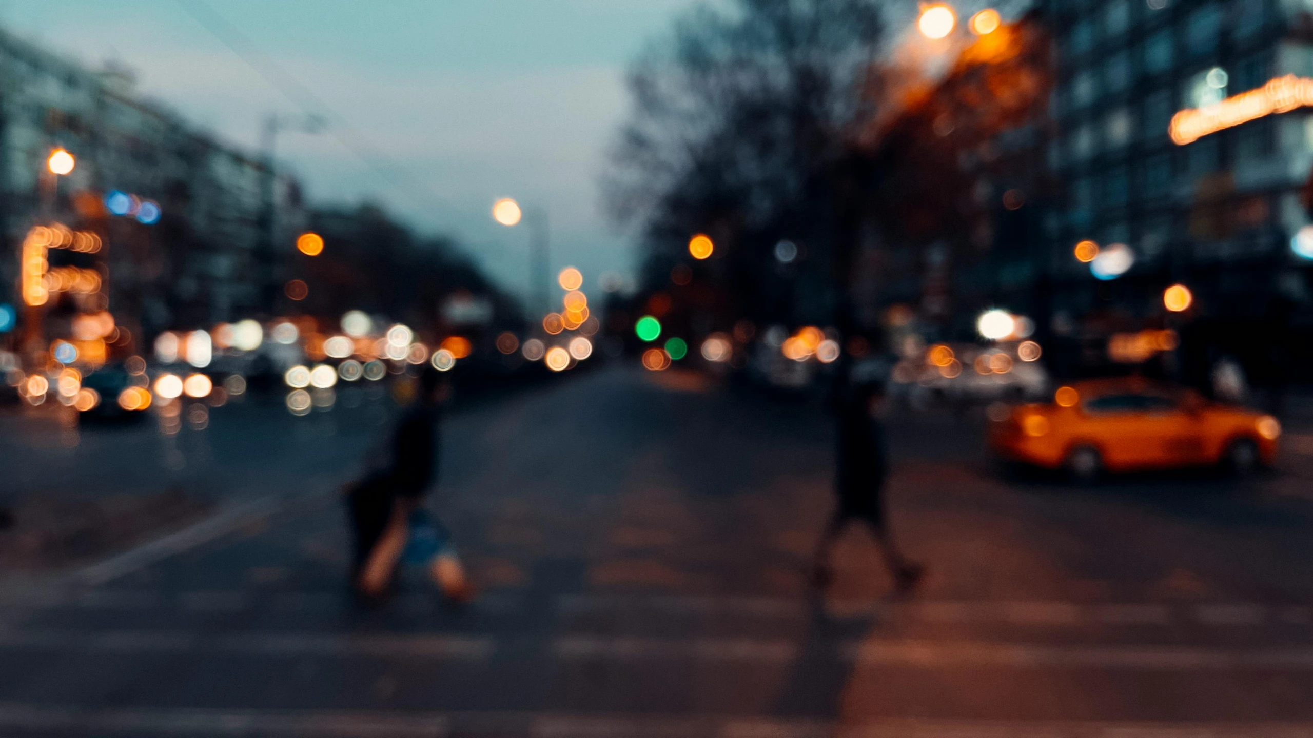 a blurry picture of a city street at night, by Niko Henrichon, pexels contest winner, happening, distant glowing figures, soft evening lighting, without text, instagram post