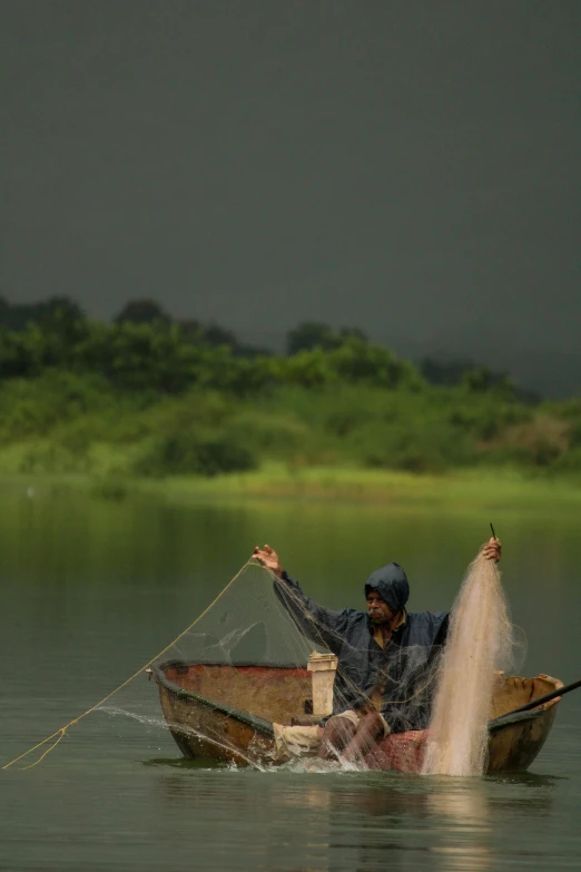 a man in a boat throwing sand into the water, by Rajesh Soni, hurufiyya, paul barson, netting, deep colours. ”, nivanh chanthara