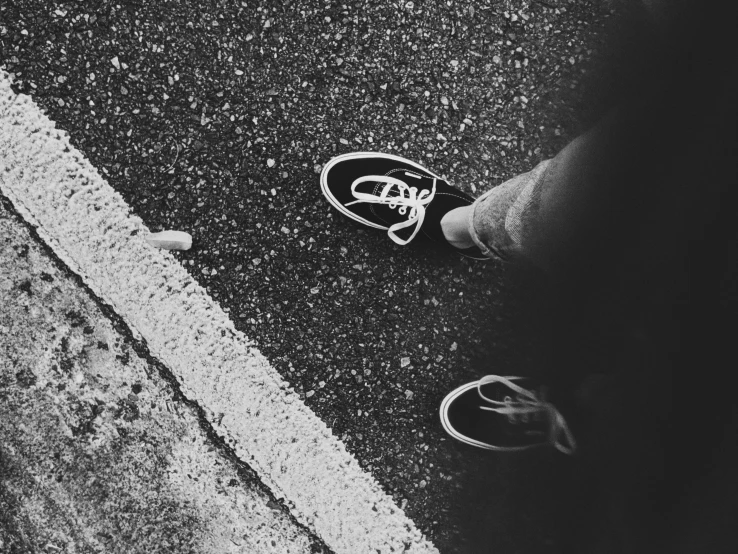 a pair of shoes sitting on the side of a road, a black and white photo, unsplash, graffiti, vsco film grain, walking over you, grunge aesthetic!!! (, shot on iphone 6