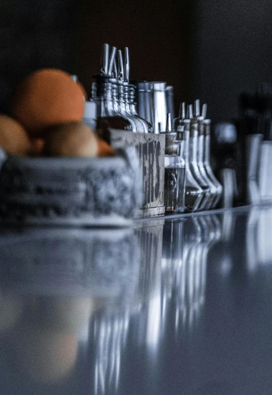 a bunch of salt and pepper shakers on a counter, unsplash, hyperrealism, reflected chrome, cocktail bar, silver egg cup, ilustration