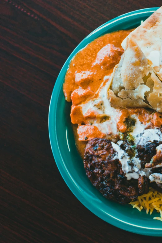 a close up of a plate of food on a table, by Matt Cavotta, trending on unsplash, indian, teal and orange colors, middle eastern skin, multiple stories