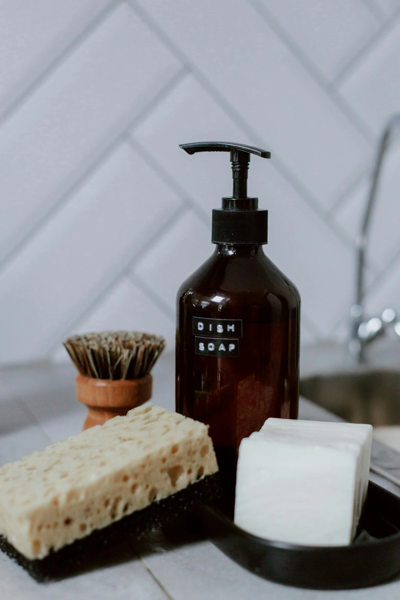 a bottle of soap sitting on top of a counter next to a soap dish, unsplash, brown, gloss finish, ingredients on the table, 3 0 0 mm