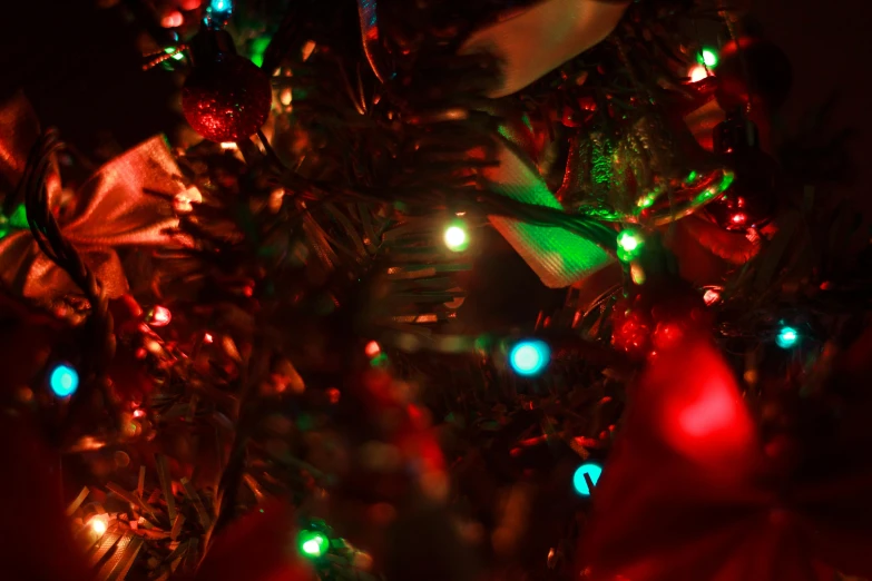 a close up of a christmas tree with lights, by David Donaldson, pexels, green blue red colors, thumbnail, shot on sony a 7, red colored