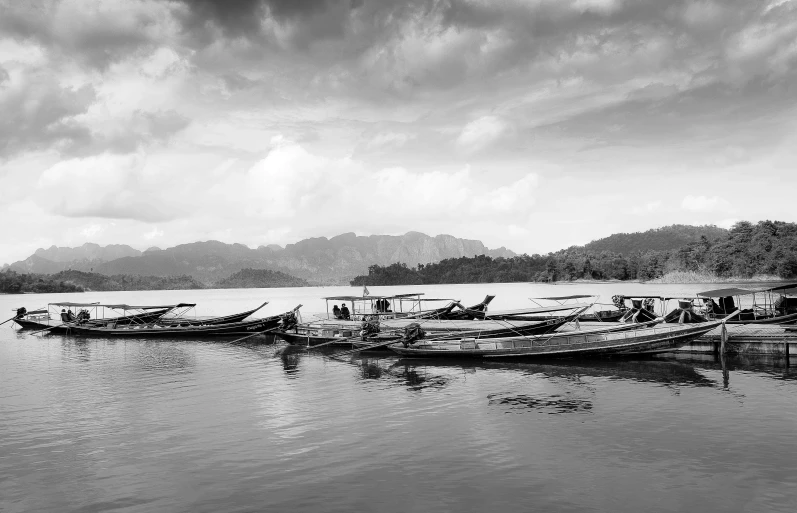 a group of boats sitting on top of a body of water, a black and white photo, pexels contest winner, visual art, laos, photographic print, fan favorite, vibrant art