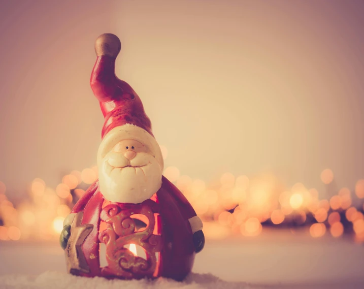 a santa claus figurine sitting in the snow, a photo, pexels contest winner, vintage glow, avatar image, small, ornament