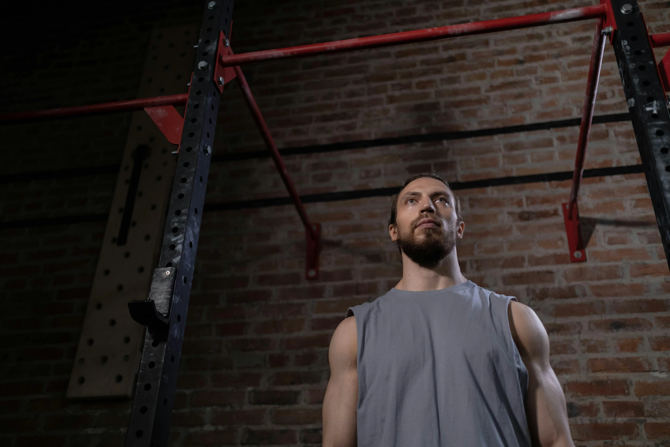 a man standing in front of a brick wall, local gym, avatar image, cinematic image, background image