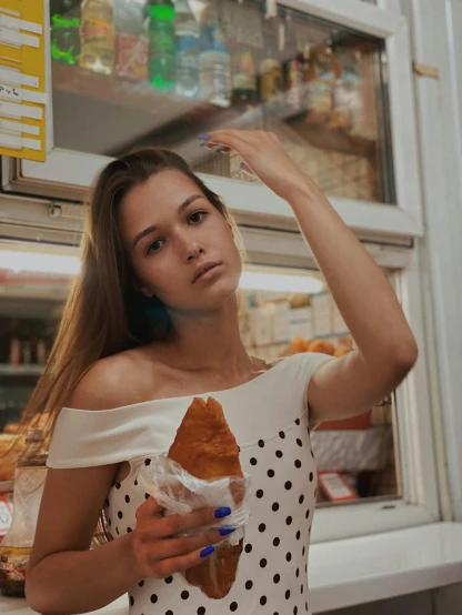a woman standing in front of a window holding a croissant, inspired by Elsa Bleda, trending on pexels, realism, holding hot sauce, 🤤 girl portrait, condorito, portrait sophie mudd