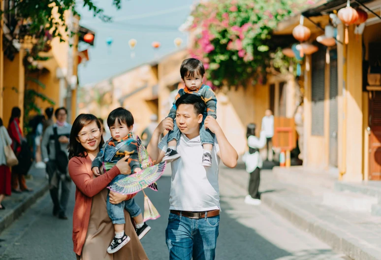 a group of people walking down a street, by Nicolette Macnamara, pexels contest winner, happy family, hoang lap, carefully crafted, avatar image