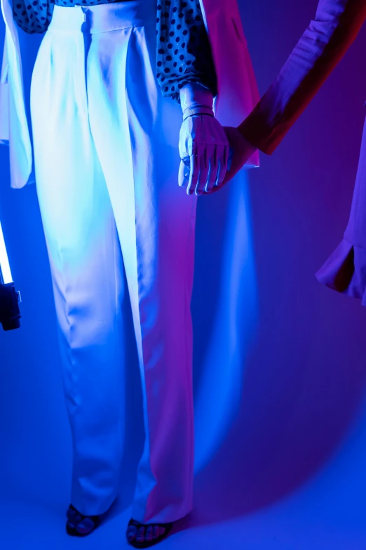 a couple of people standing next to each other, inspired by Nan Goldin, aestheticism, blue lightsaber, teamlab, details and vivid colors, white clothes