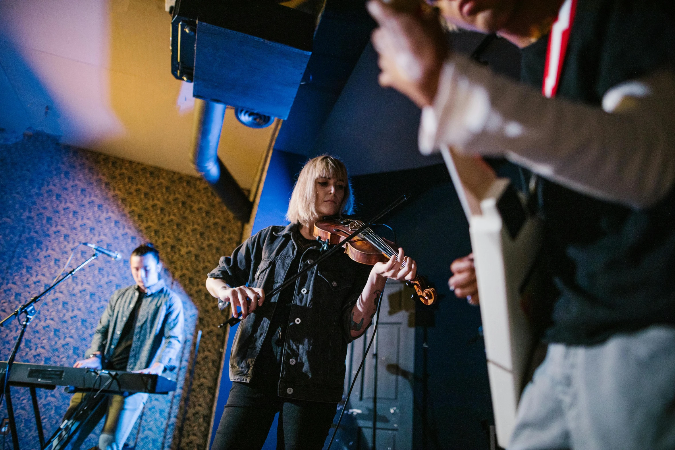 a man standing next to a woman playing a violin, unsplash, happening, saturday night in a saloon, sonic youth, panoramic shot, thumbnail