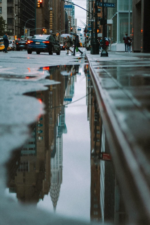 a puddle of water in the middle of a city street, a picture, by Dan Christensen, pexels contest winner, panoramic anamorphic, nyc, medium long shot, square