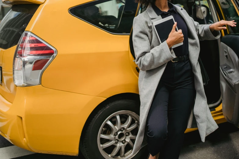 a woman standing next to a yellow car, grey turtleneck coat, walking to work, professional grade, taxi