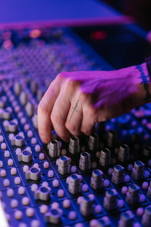 a close up of a person's hand on a mixing board, by artist, blue lights and purple lights, profile pic, promo image, multiple stories