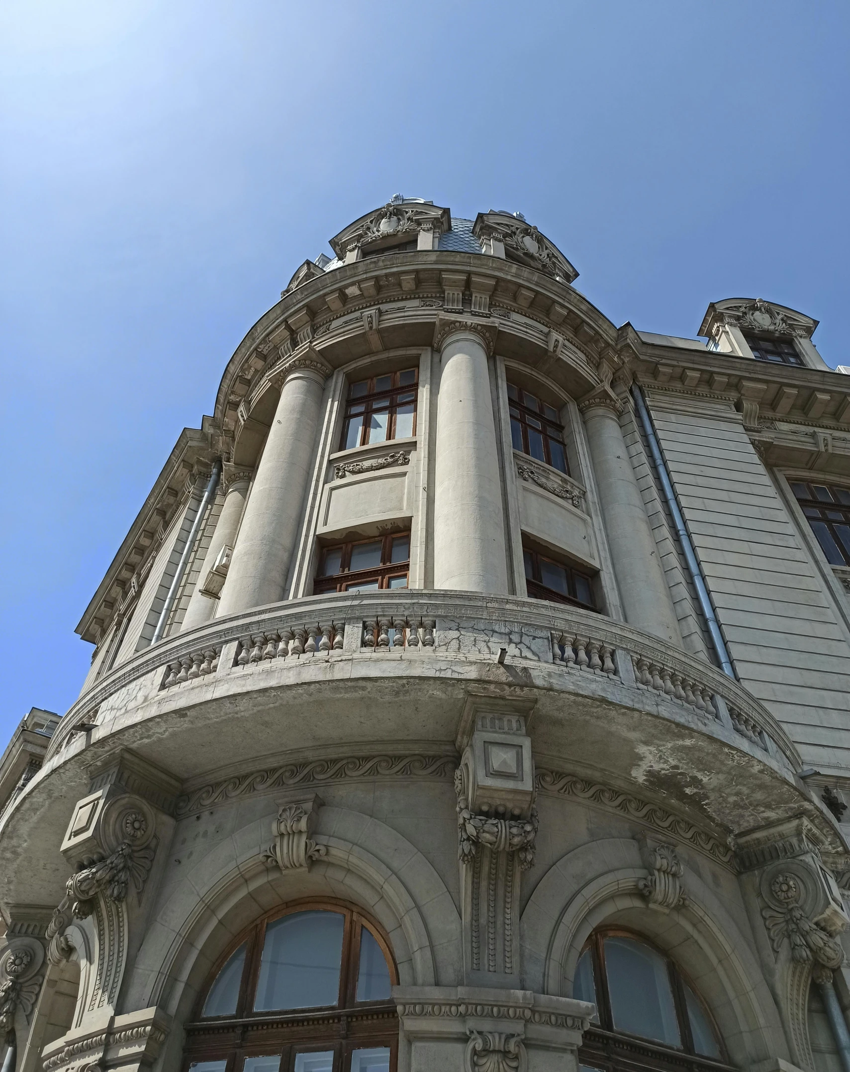 a tall building with a clock on the front of it, art nouveau, limestone, huge mansion, buenos aires, curvy build