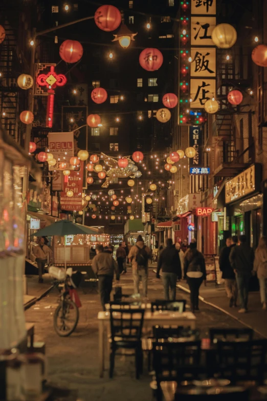 a group of people walking down a street at night, chinatown, decorations, london at night, amsterdam