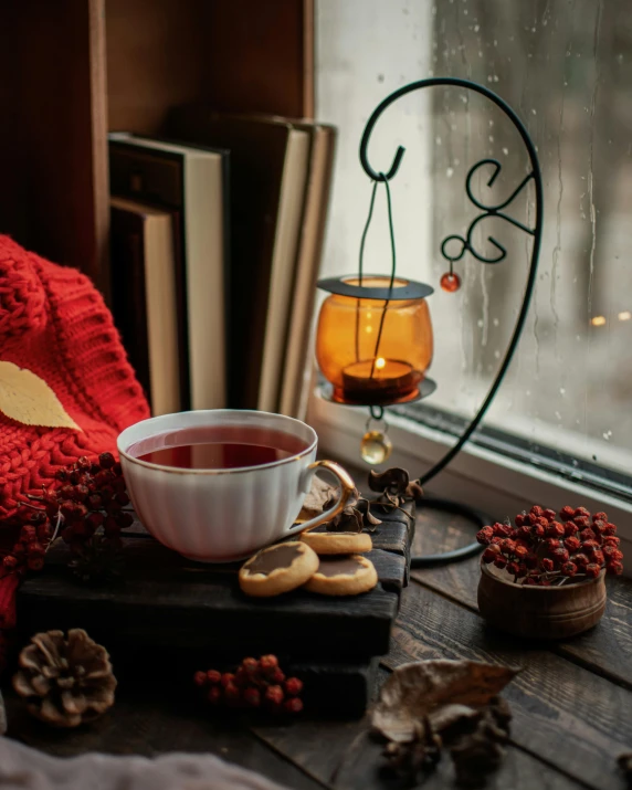 a cup of tea sitting on top of a wooden table, by Emma Andijewska, pexels contest winner, romanticism, festive atmosphere, square, 15081959 21121991 01012000 4k, crimson accents