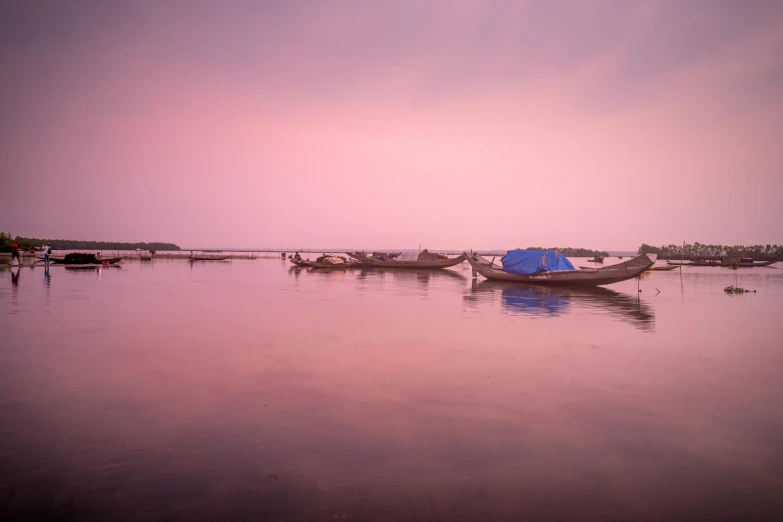 a group of boats sitting on top of a body of water, by Basuki Abdullah, pexels contest winner, romanticism, pink hues, cambodia, slide show, photographic print