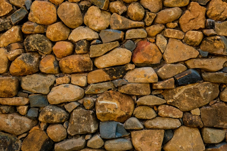a red fire hydrant sitting on top of a pile of rocks, an album cover, unsplash, renaissance, seamless texture, ((rocks)), brown cobble stones, multi - coloured