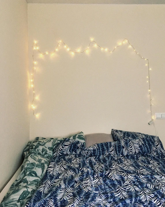 a bed room with a neatly made bed, an album cover, inspired by Sophia Beale, featured on instagram, light and space, fairy lights, high angle close up shot, basic white background, rgb wall light
