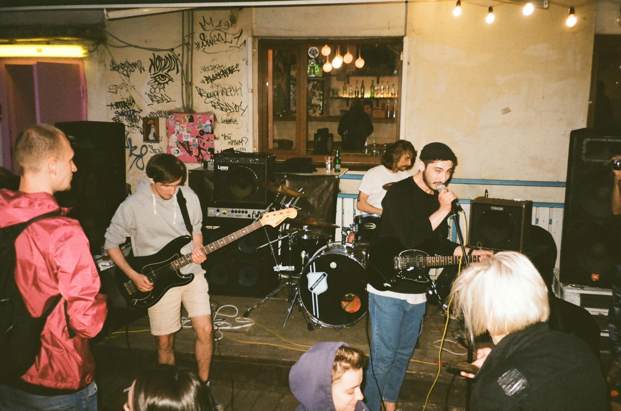 a group of people that are standing in a room, an album cover, unsplash, punk concert, bumpy, live performance, whitewashed housed