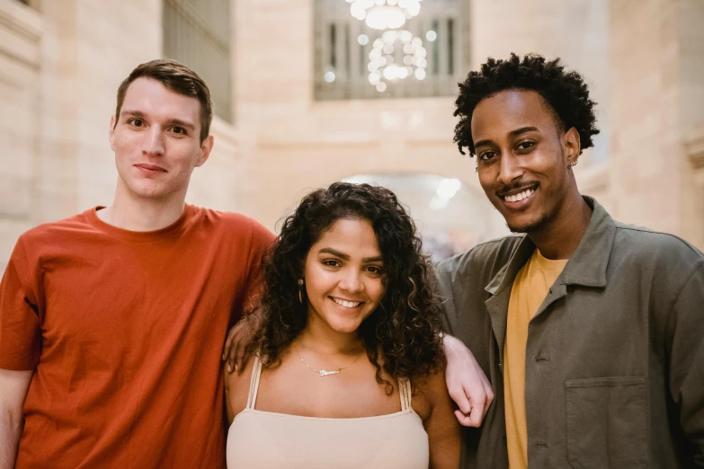 a group of three people standing next to each other, pexels contest winner, light brown skin, college students, friendly face, indoor picture